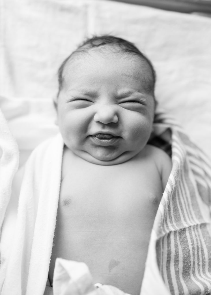 Newborn baby making a silly face