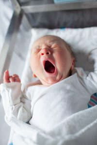 Newborn baby yawning in hospital