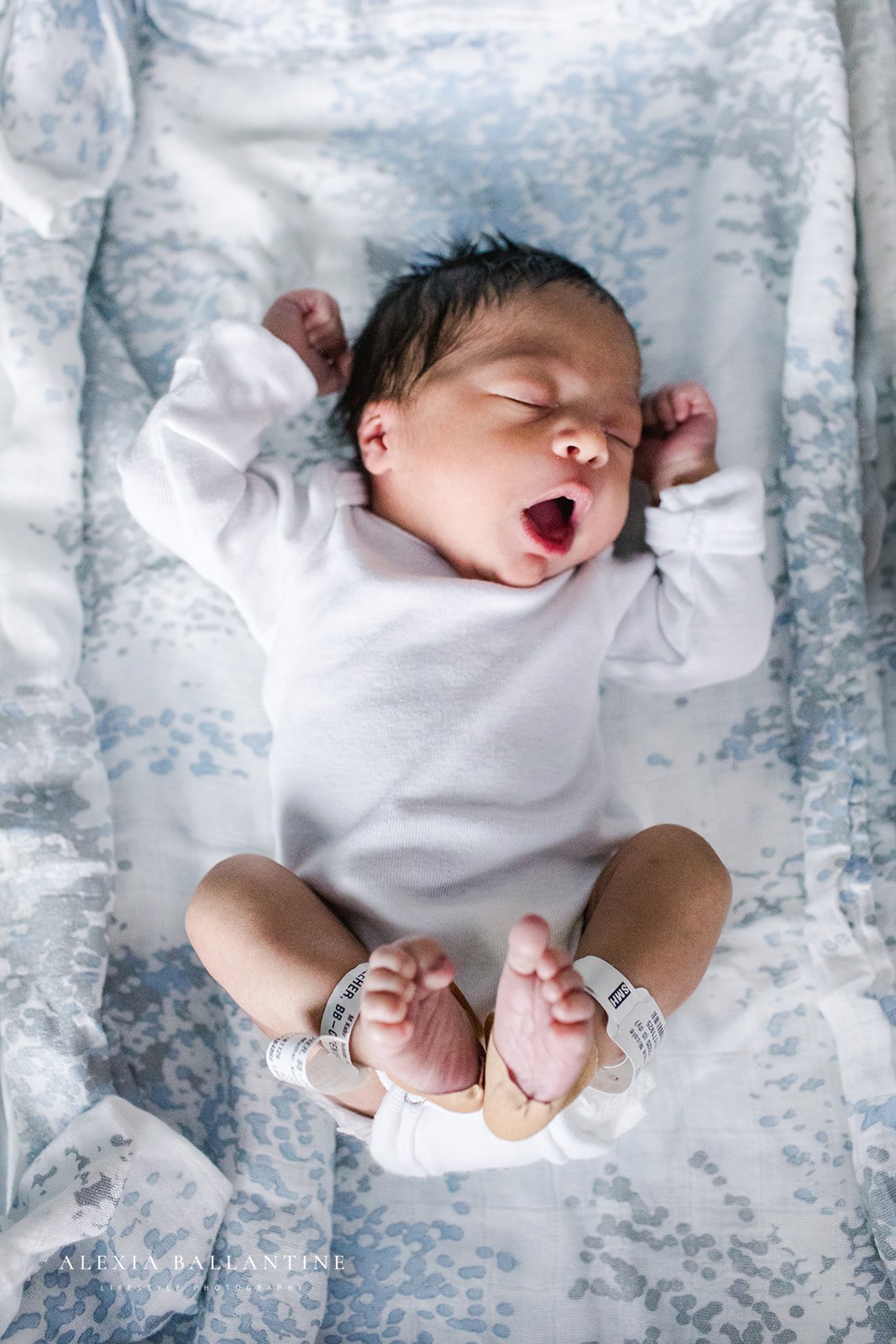 Newborn baby stretching and yawning