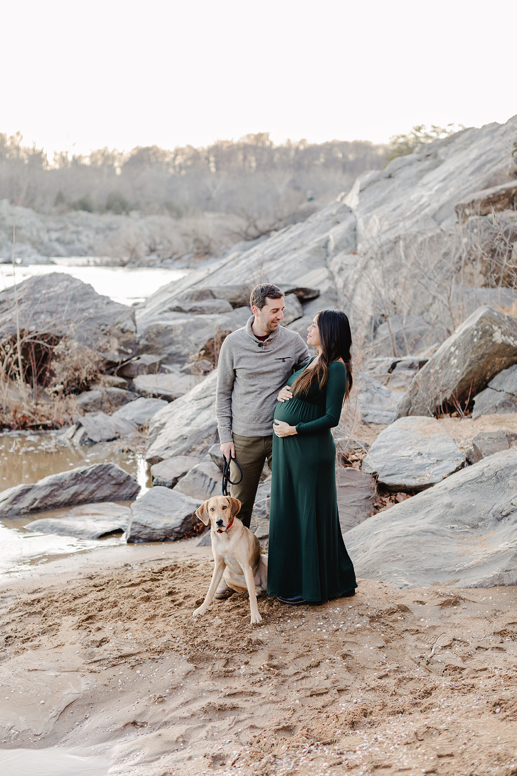 northern virginia couple expecting a baby being photographed by a river