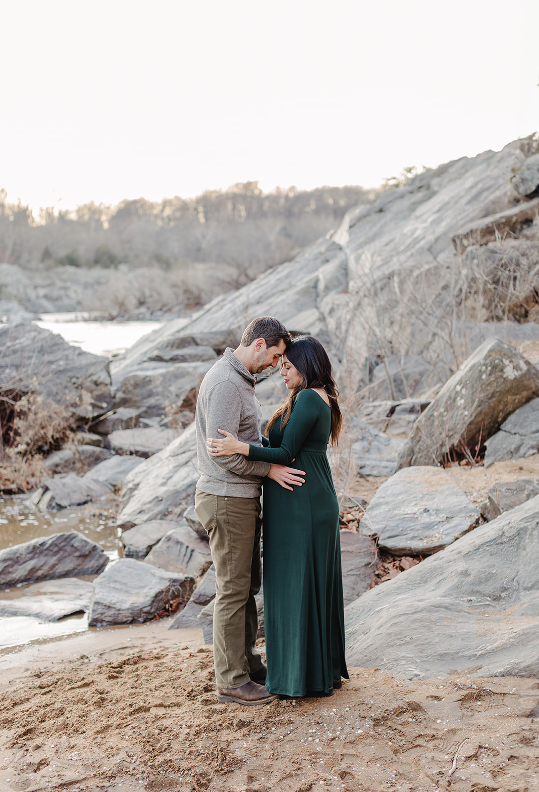 northern virginia couple expecting a baby being photographed by a river