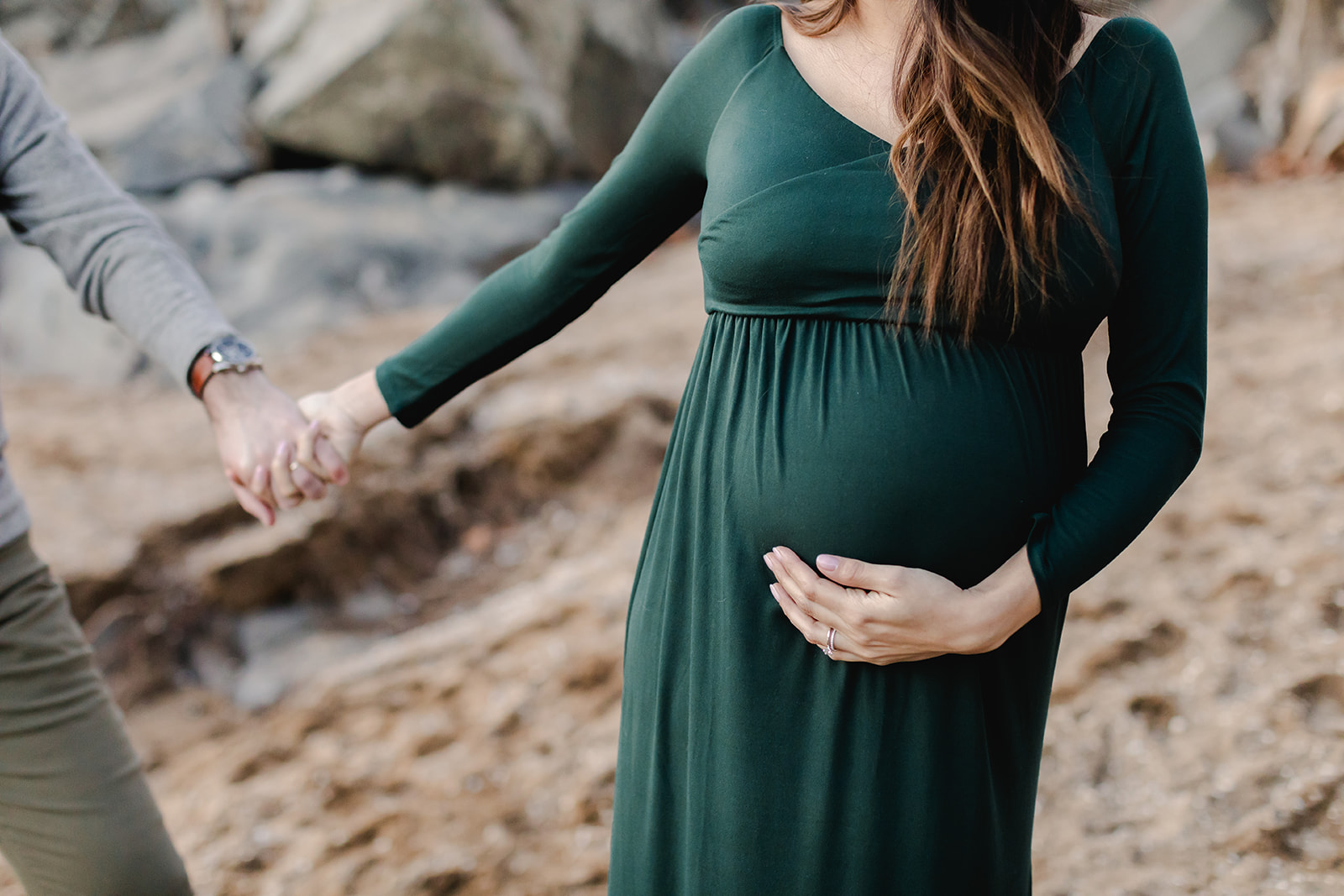 maternity photos by a river and cliffs