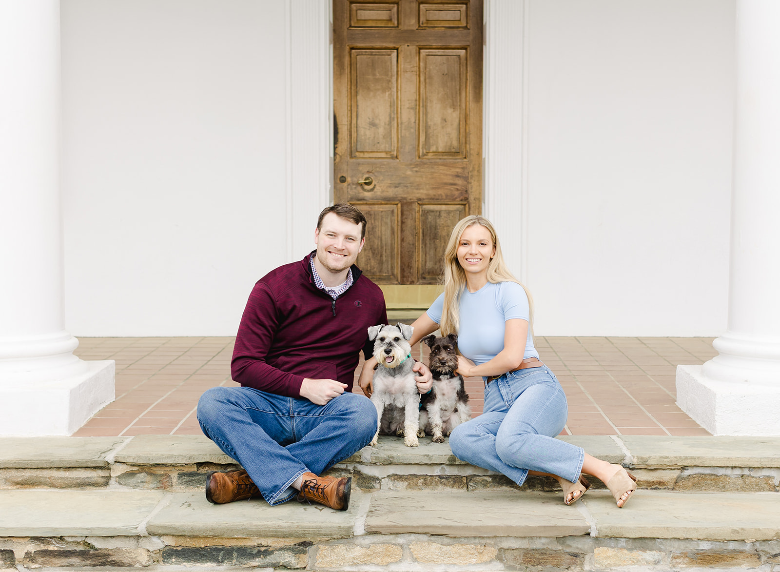 family with their two dogs walking in a garden
