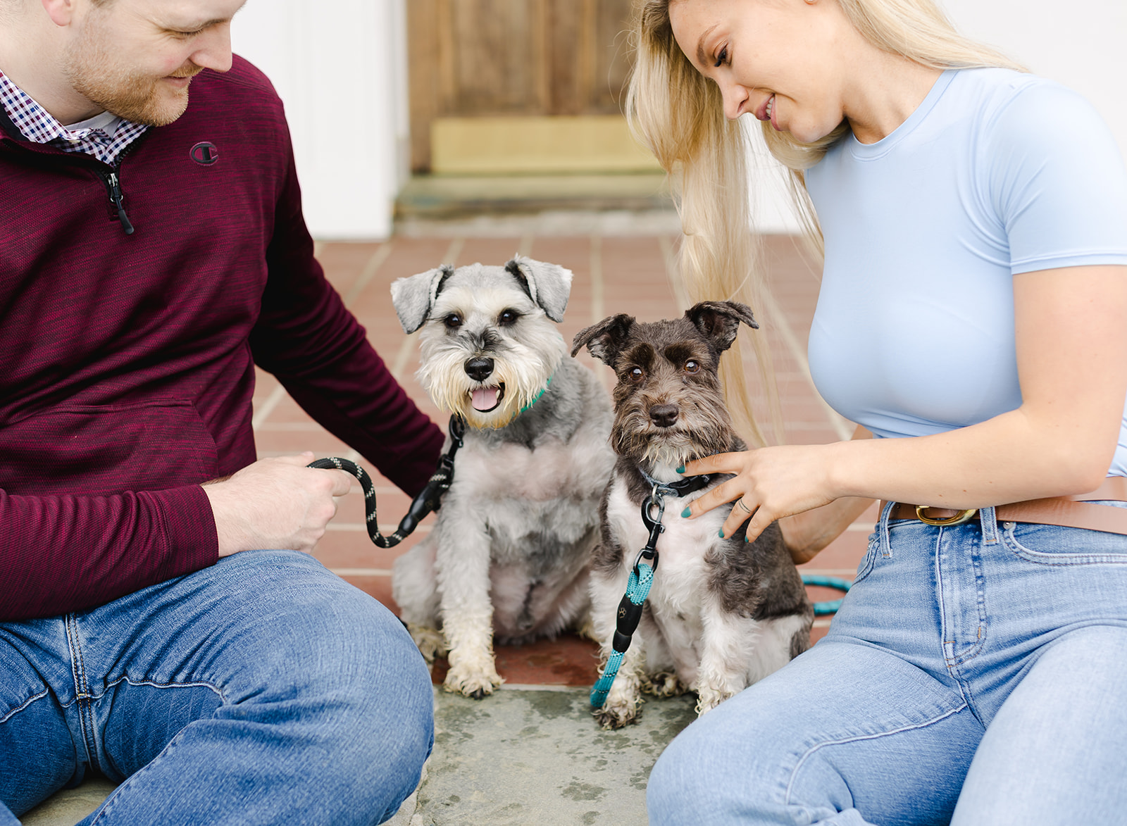 family with their two dogs walking in a garden