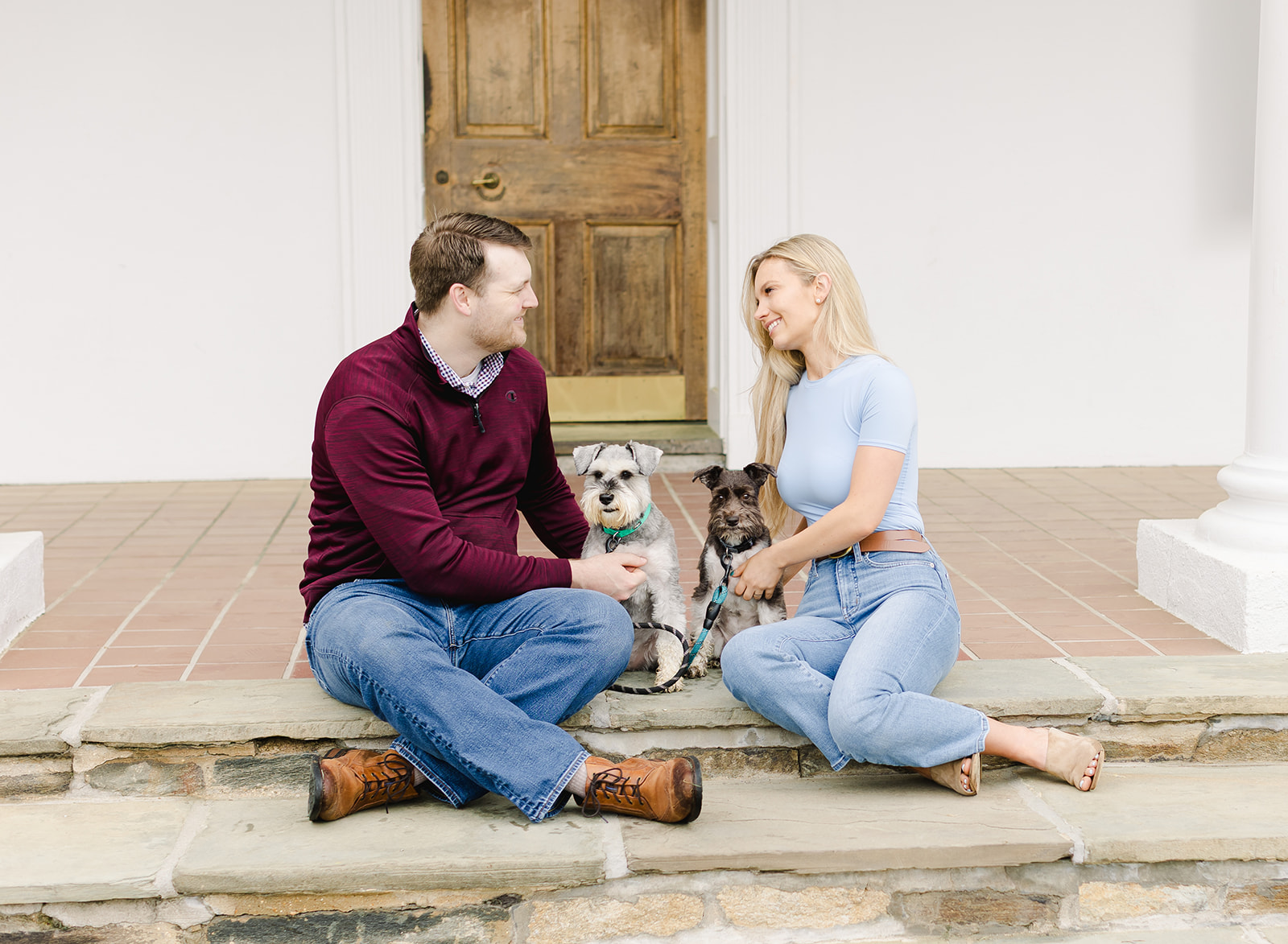 family with their two dogs walking in a garden