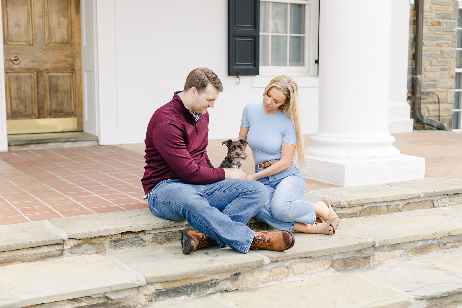 family with their two dogs walking in a garden