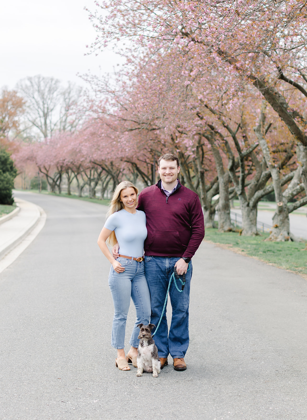 family with their two dogs walking in a garden