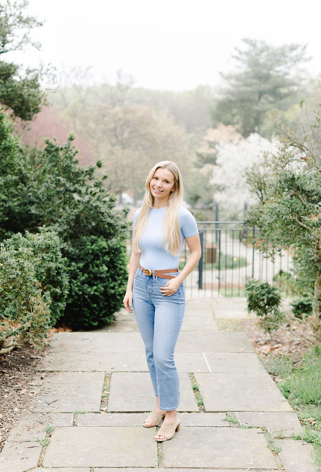 headshot of a beautiful blonde woman wearing a blue shirt and jeans