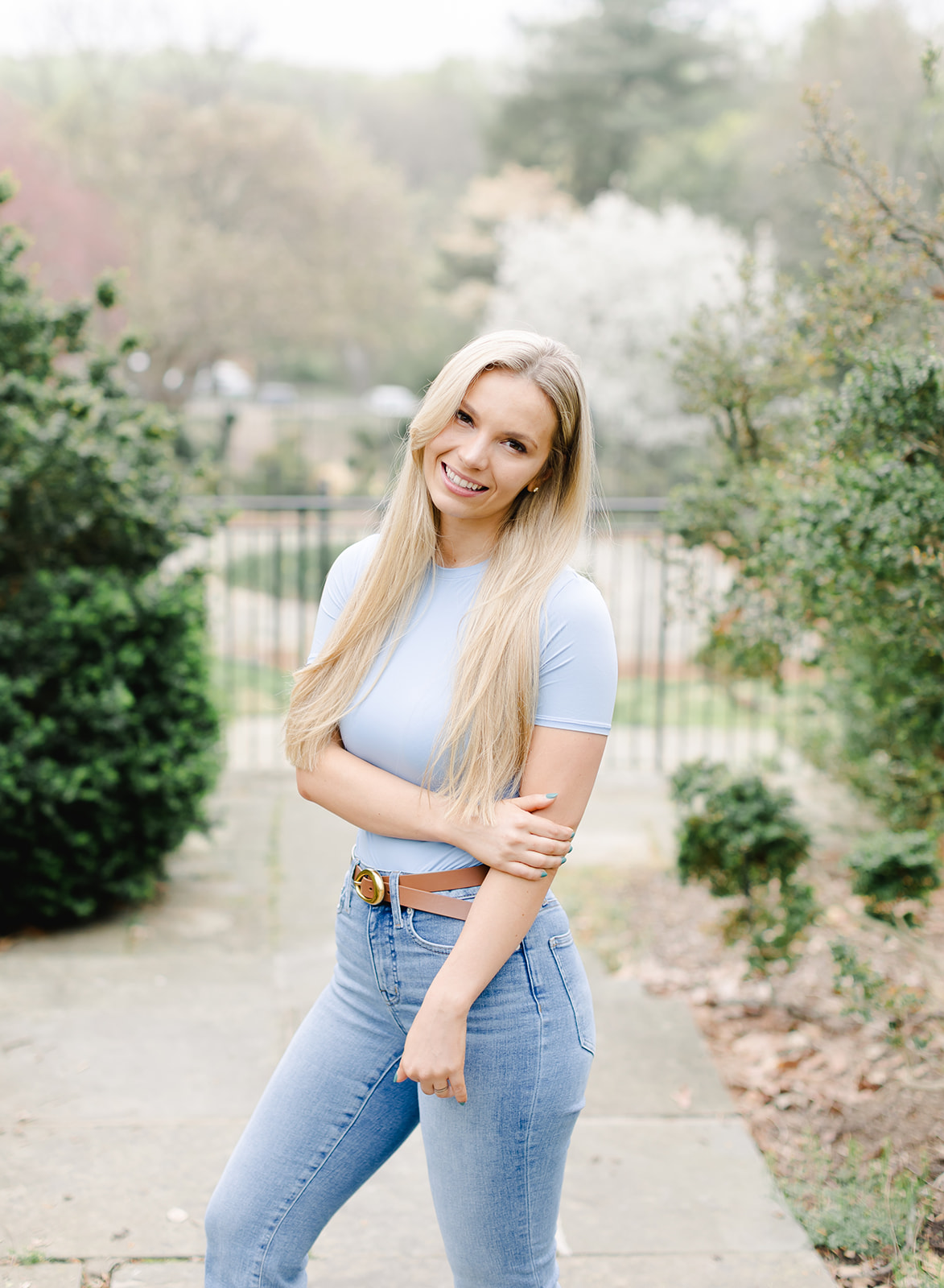 headshot of a beautiful blonde woman wearing a blue shirt and jeans
