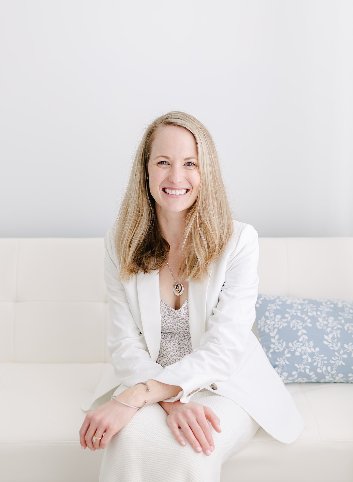 headshots of a woman wearing a white blazer