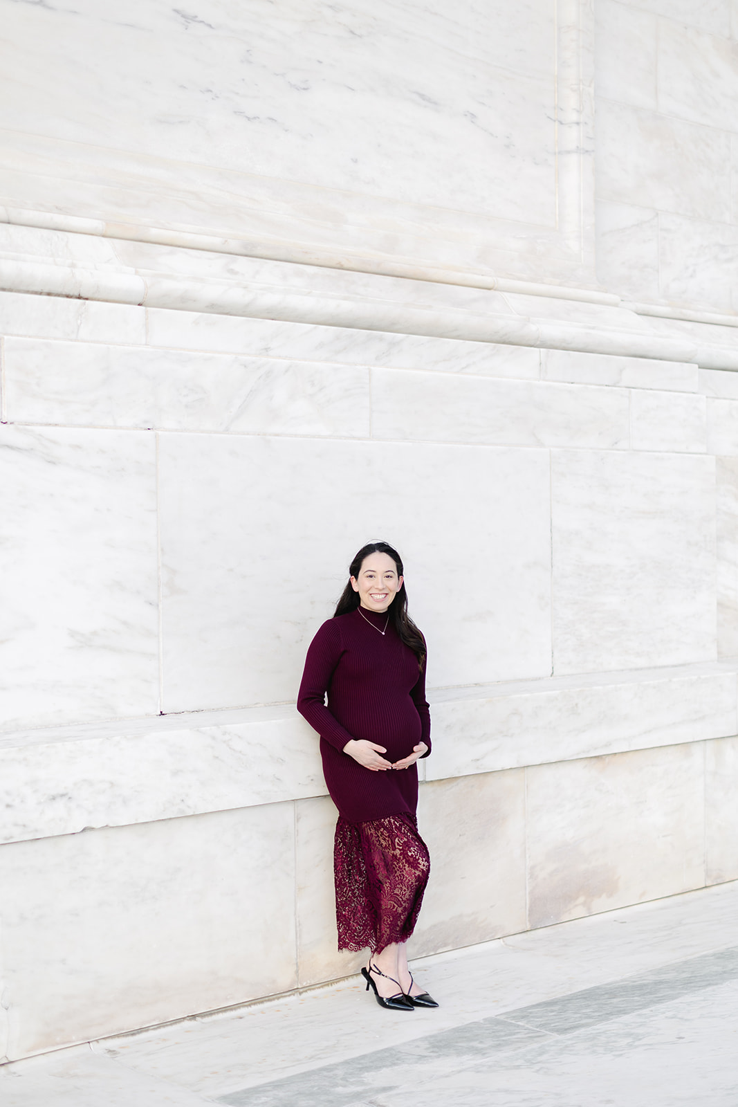 Pregnant mom in a maroon dress in front of the US capital