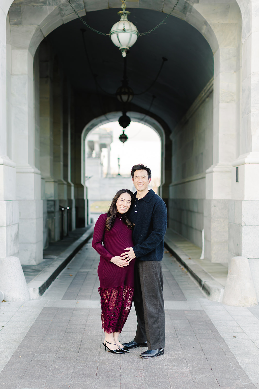 Couple expecting a baby standing together in front of the Capital building