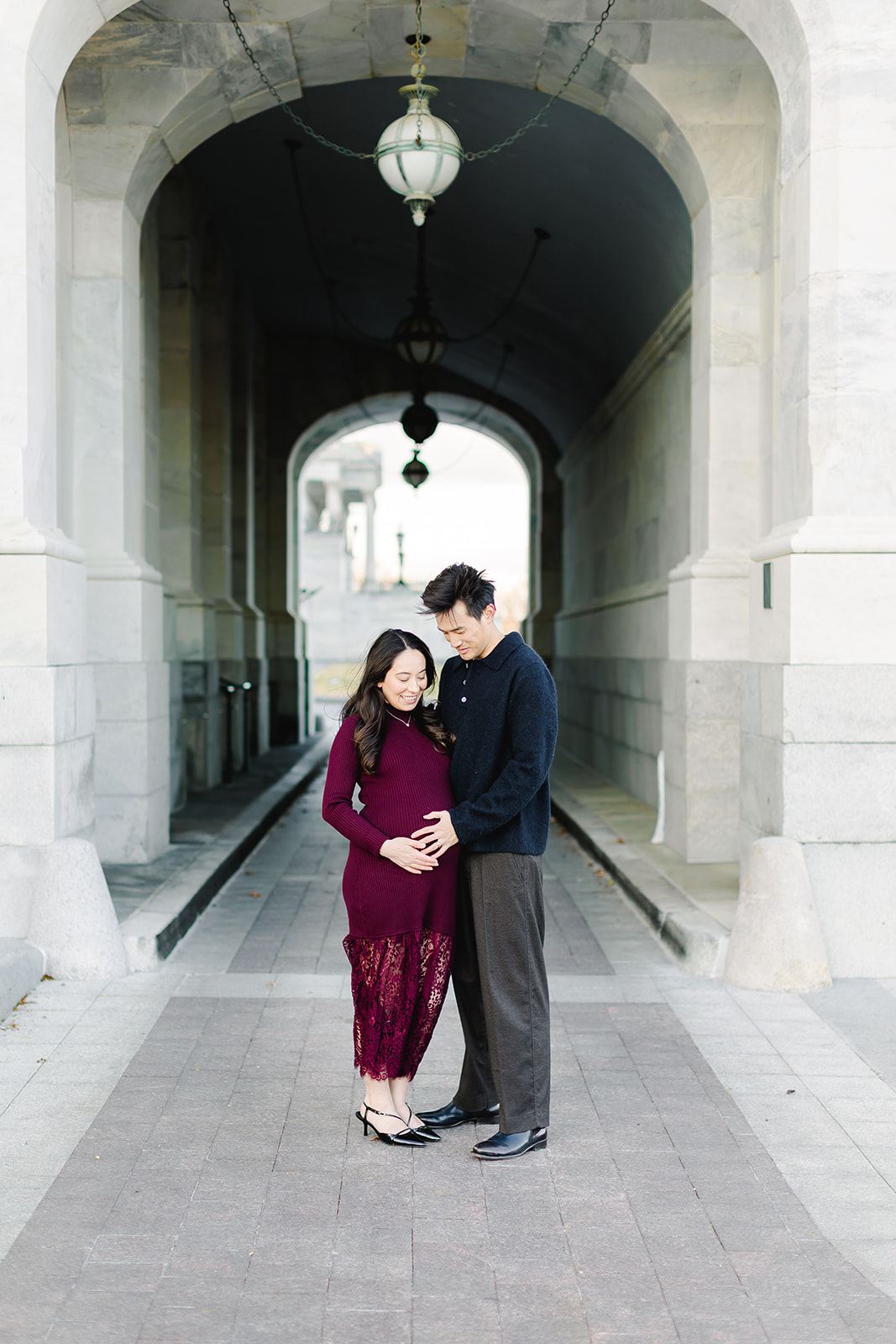 Couple expecting a baby standing together in front of the Capital building