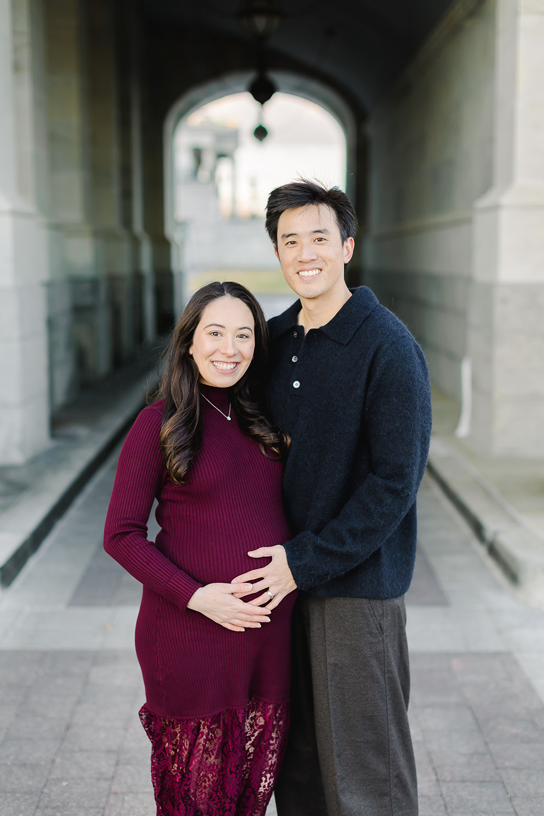 Couple expecting a baby standing together in front of the Capital building