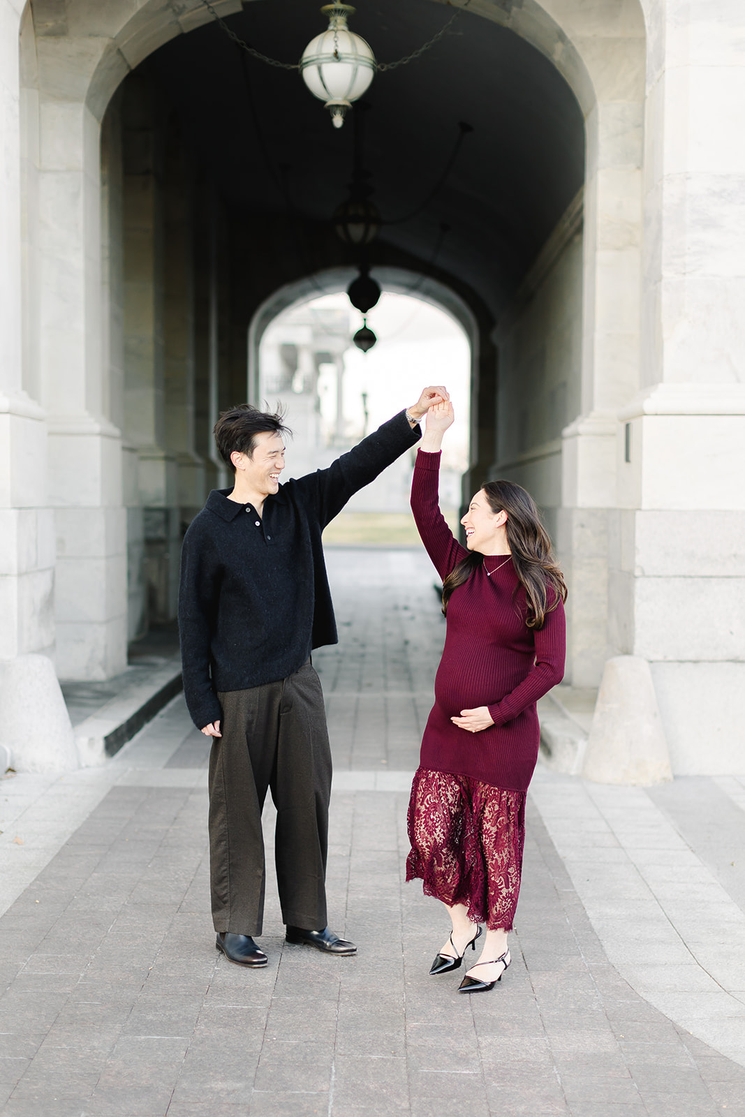 Couple expecting a baby dancing in front of the Capital building