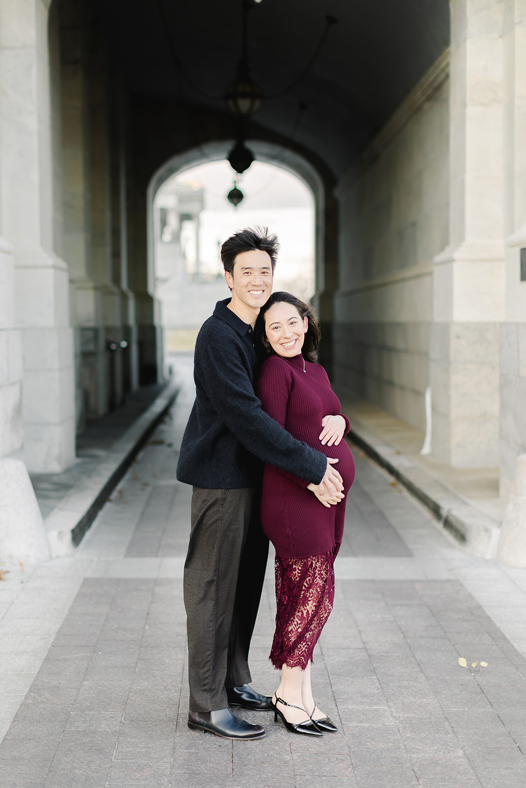 Couple expecting a baby standing together in front of the Capital building